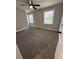 Spacious carpeted bedroom with neutral walls, ceiling fan, and natural light from two windows at 2764 Ocean Valley Dr, Atlanta, GA 30349
