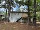Back of house with a newly-built deck and black stairs leading to a white basement door at 2764 Ocean Valley Dr, Atlanta, GA 30349