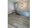 Bright hallway featuring wood floors, an iron railing, and a modern chandelier at 2764 Ocean Valley Dr, Atlanta, GA 30349