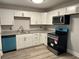 Modern kitchen features white cabinets, stainless steel appliances, and stylish granite countertops at 2764 Ocean Valley Dr, Atlanta, GA 30349