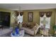 Inviting living room featuring a comfortable sofa, chandelier, and bright windows at 3939 Craggy Perch, Douglasville, GA 30135