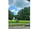Scenic view of a quiet street, lush trees, and a charming home in the distance at 3939 Craggy Perch, Douglasville, GA 30135