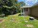 Lush backyard with lawn and screened porch of the home at 10 Vaughan Ne Ct, Cartersville, GA 30121