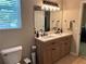 Double vanity in bathroom with white counters, dark hardware, and framed mirror with vanity lighting at 10 Vaughan Ne Ct, Cartersville, GA 30121