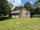Well-maintained home with green shutters and a welcoming front porch, surrounded by lush lawn at 10 Vaughan Ne Ct, Cartersville, GA 30121