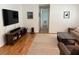Comfortable living room with sleek media center, contemporary furnishings, and warm hardwood floors at 10 Vaughan Ne Ct, Cartersville, GA 30121
