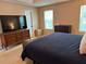 Spacious bedroom featuring dresser, a large TV, and carpet floors at 10 Vaughan Ne Ct, Cartersville, GA 30121
