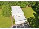 Aerial view displays bright, contemporary home with a multi-car garage surrounded by a verdant lawn at 110 Bridger Point Rd, Fayetteville, GA 30215