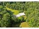 Expansive aerial view showcases a modern home nestled within a dense, green forest at 110 Bridger Point Rd, Fayetteville, GA 30215