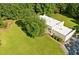An aerial shot of a modern home surrounded by a lush lawn and mature trees at 110 Bridger Point Rd, Fayetteville, GA 30215