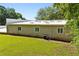 Backyard showing a modern home with bright white roof and green lawn at 110 Bridger Point Rd, Fayetteville, GA 30215