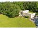 Unique home boasting a lush green lawn, mature trees, and a multi-car garage at 110 Bridger Point Rd, Fayetteville, GA 30215