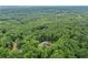 Breathtaking aerial shot showcasing a private home nestled within a dense, verdant forest at 2100 Mountain Cove Ct, Woodstock, GA 30188