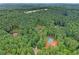 Panoramic aerial perspective of a home nestled among towering trees, emphasizing privacy and natural beauty at 2100 Mountain Cove Ct, Woodstock, GA 30188