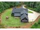 Scenic aerial view of a contemporary home nestled on a private lot with mature trees and landscaping at 2100 Mountain Cove Ct, Woodstock, GA 30188