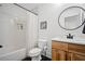 Modern bathroom featuring subway tile shower, wood vanity, and black accents at 2100 Mountain Cove Ct, Woodstock, GA 30188
