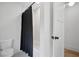 Clean bathroom with a black shower curtain, and white fixtures at 2100 Mountain Cove Ct, Woodstock, GA 30188