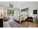 Inviting bedroom with a canopy bed, large windows, and tranquil views at 2100 Mountain Cove Ct, Woodstock, GA 30188
