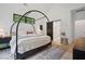Bright bedroom with a canopy bed, stylish decor, and ensuite bathroom access at 2100 Mountain Cove Ct, Woodstock, GA 30188