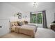 Bright bedroom with two twin beds, modern lighting, and large windows offering a view at 2100 Mountain Cove Ct, Woodstock, GA 30188