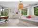 Sunlit bedroom with a cozy bed, hanging chair, and a view of the trees at 2100 Mountain Cove Ct, Woodstock, GA 30188