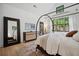 Serene bedroom features a canopy bed, large windows, and elegant furnishings at 2100 Mountain Cove Ct, Woodstock, GA 30188