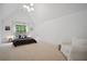 Spacious bedroom with high ceilings, a cozy seating area, and natural light at 2100 Mountain Cove Ct, Woodstock, GA 30188