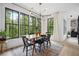 Bright dining area with large windows offering lush views, complete with modern furnishings and decor at 2100 Mountain Cove Ct, Woodstock, GA 30188