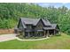 Beautiful new construction home boasts a three car garage, basketball court and relaxing front porch at 2100 Mountain Cove Ct, Woodstock, GA 30188