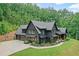 Beautiful new construction home boasts a three car garage, basketball court and front porch at 2100 Mountain Cove Ct, Woodstock, GA 30188