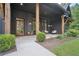 Charming front porch featuring modern black brick, natural wood accents and stylish outdoor seating at 2100 Mountain Cove Ct, Woodstock, GA 30188