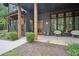 Welcoming front porch with brick accents, decorative chairs, and bright lighting fixtures at 2100 Mountain Cove Ct, Woodstock, GA 30188