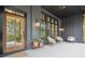 Inviting front porch featuring black brick accents, a wood door, and ample seating space at 2100 Mountain Cove Ct, Woodstock, GA 30188