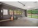 Bright garage with black accent wall, many windows, and door leading to back yard at 2100 Mountain Cove Ct, Woodstock, GA 30188