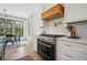 Modern kitchen with stainless steel appliances, white cabinets, and an adjacent dining area with views at 2100 Mountain Cove Ct, Woodstock, GA 30188