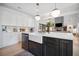Bright kitchen with a modern island, stainless steel appliances, white cabinets, and stylish pendant lighting at 2100 Mountain Cove Ct, Woodstock, GA 30188