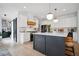 Modern kitchen with a dark island, white cabinets, stainless steel appliances, and stylish lighting at 2100 Mountain Cove Ct, Woodstock, GA 30188