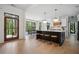 Bright kitchen featuring a large island with seating, modern lighting, and stainless steel appliances at 2100 Mountain Cove Ct, Woodstock, GA 30188