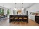 Spacious kitchen island with seating, pendant lights, and stainless steel appliances, next to the dining area at 2100 Mountain Cove Ct, Woodstock, GA 30188
