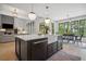 Bright kitchen featuring a large island, stainless steel appliances, and an adjacent dining area at 2100 Mountain Cove Ct, Woodstock, GA 30188