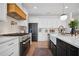 Well-equipped kitchen featuring stainless steel appliances, white cabinets, and a farmhouse sink at 2100 Mountain Cove Ct, Woodstock, GA 30188