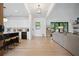 Bright open-concept living room with hardwood floors, modern decor, and seamless flow to the kitchen at 2100 Mountain Cove Ct, Woodstock, GA 30188
