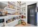 Well-organized walk-in pantry with ample shelving for storage and convenient access at 2100 Mountain Cove Ct, Woodstock, GA 30188