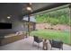 Inviting covered patio featuring ceiling fans, comfortable seating, and a view of the lush, landscaped backyard at 2100 Mountain Cove Ct, Woodstock, GA 30188