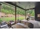 Comfortable covered patio with a full outdoor kitchen, a lounge area and a large grassy play area at 2100 Mountain Cove Ct, Woodstock, GA 30188