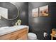 Stylish powder room features shiplap walls, modern fixtures, and mountain artwork at 2100 Mountain Cove Ct, Woodstock, GA 30188