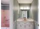 Cozy bathroom with a tub, vanity, and floral wallpaper at 6339 Cornelia Dr, Douglasville, GA 30134