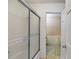 Bathroom view showcasing the shower, patterned walls, and a doorway to an adjacent room at 6339 Cornelia Dr, Douglasville, GA 30134