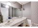 Bathroom featuring a large mirror, classic vanity, and traditional wallpaper design at 6339 Cornelia Dr, Douglasville, GA 30134