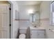 Compact bathroom with a white vanity, tiled walls, and a classic, functional layout at 6339 Cornelia Dr, Douglasville, GA 30134